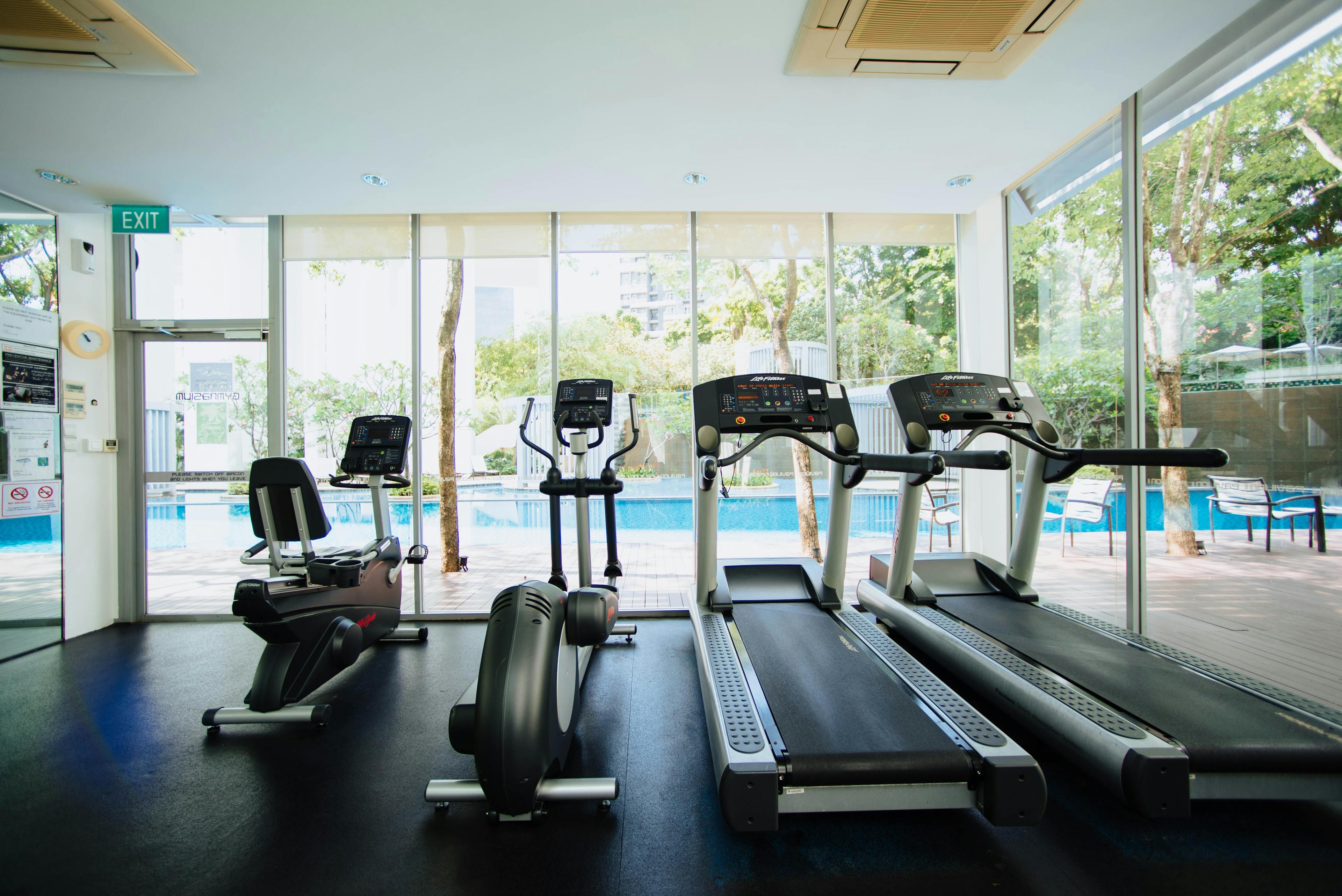 Photo of various gym equipment including a tread mill and elliptical machine