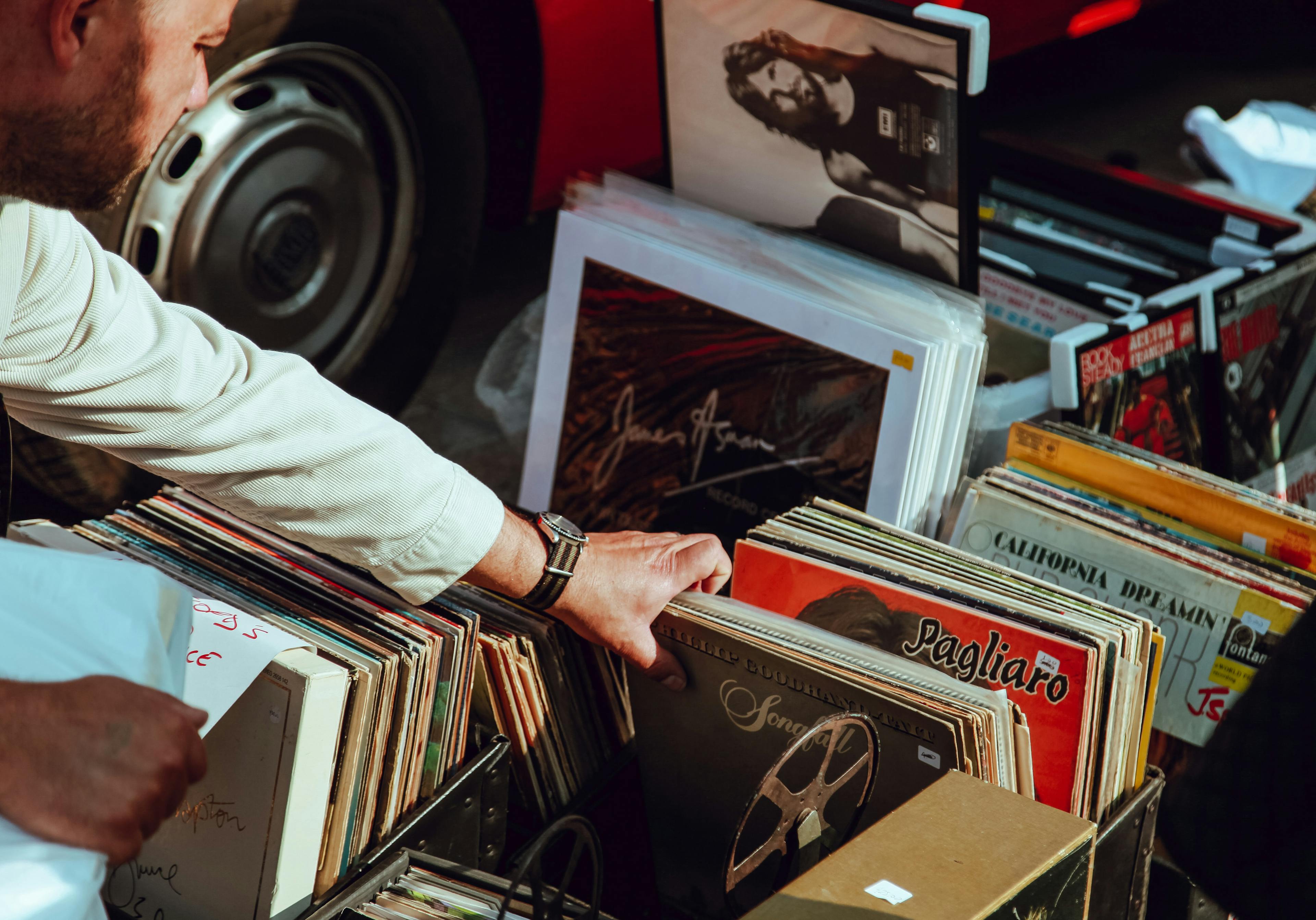Man looking through records at a garage sale